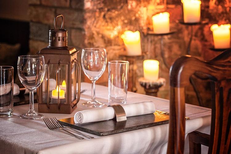 A candlelit table with a lantern at East India Cafe, Cheltenham