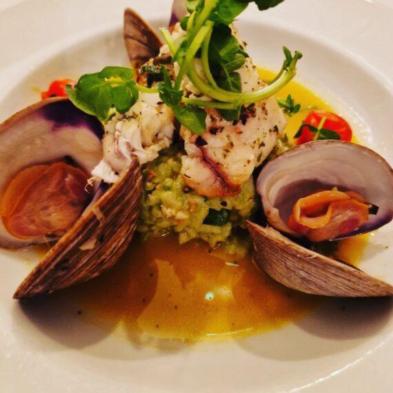 Fish on crushed vegetables with clams in a saffron broth at Primavera Ristorante, Cheltenham