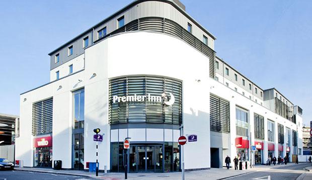The white corner building of Premier Inn Cheltenham Town Centre on Henrietta Street